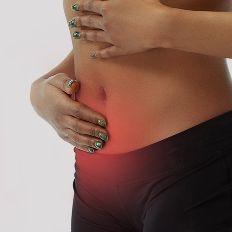a person holding her abdomen because of pain