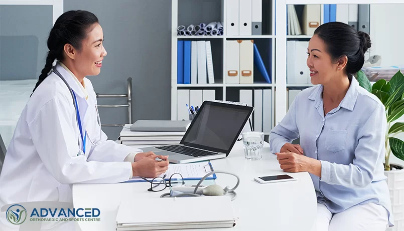 doctor and patient conversing about knee replacement surgery